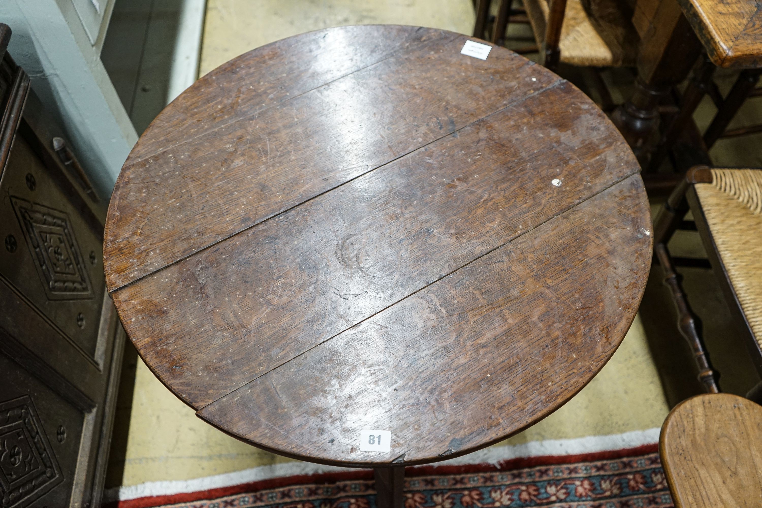 A George III oak cricket table, with circular top on tapered triangular legs, diameter 71cm height 72cm